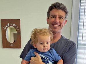 Third generation chiropractor holding fourth generation patient.